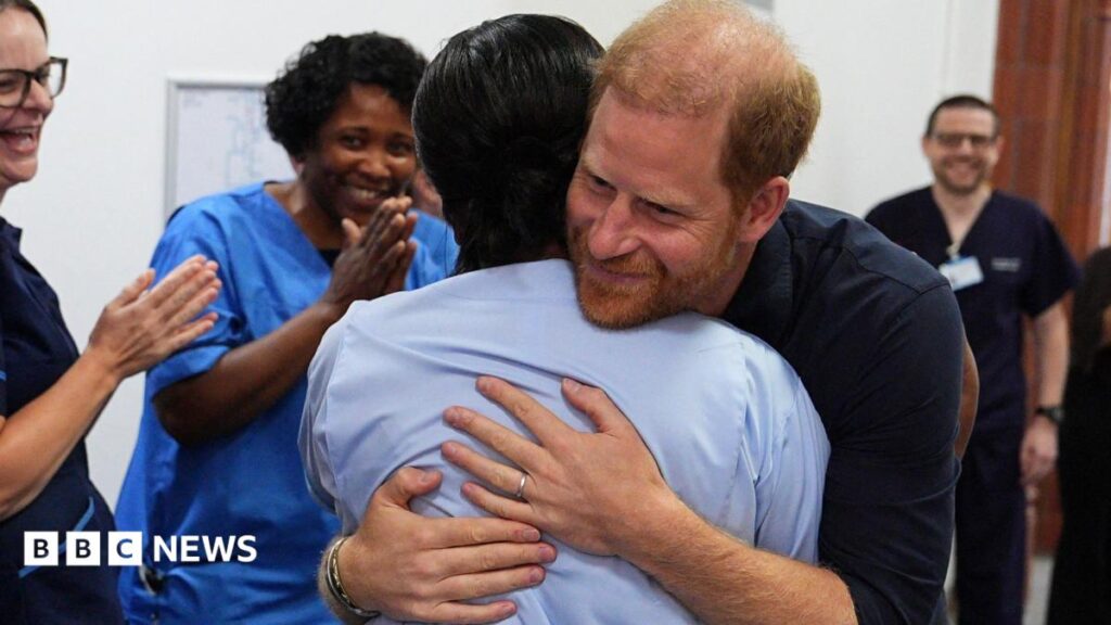 Prince Harry hugs a nurse on his visit to Birmingham Children's Hospital