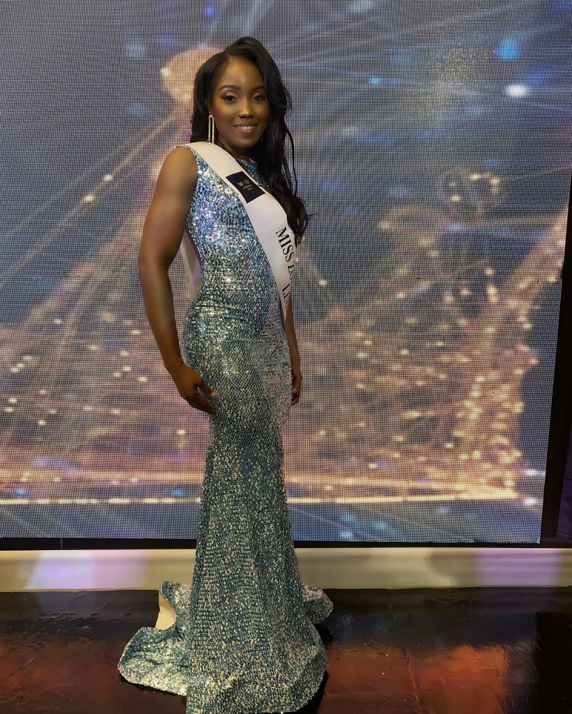 LaToya Malcolm in a sequined gown and a "Miss Universe Jamaica" sash.