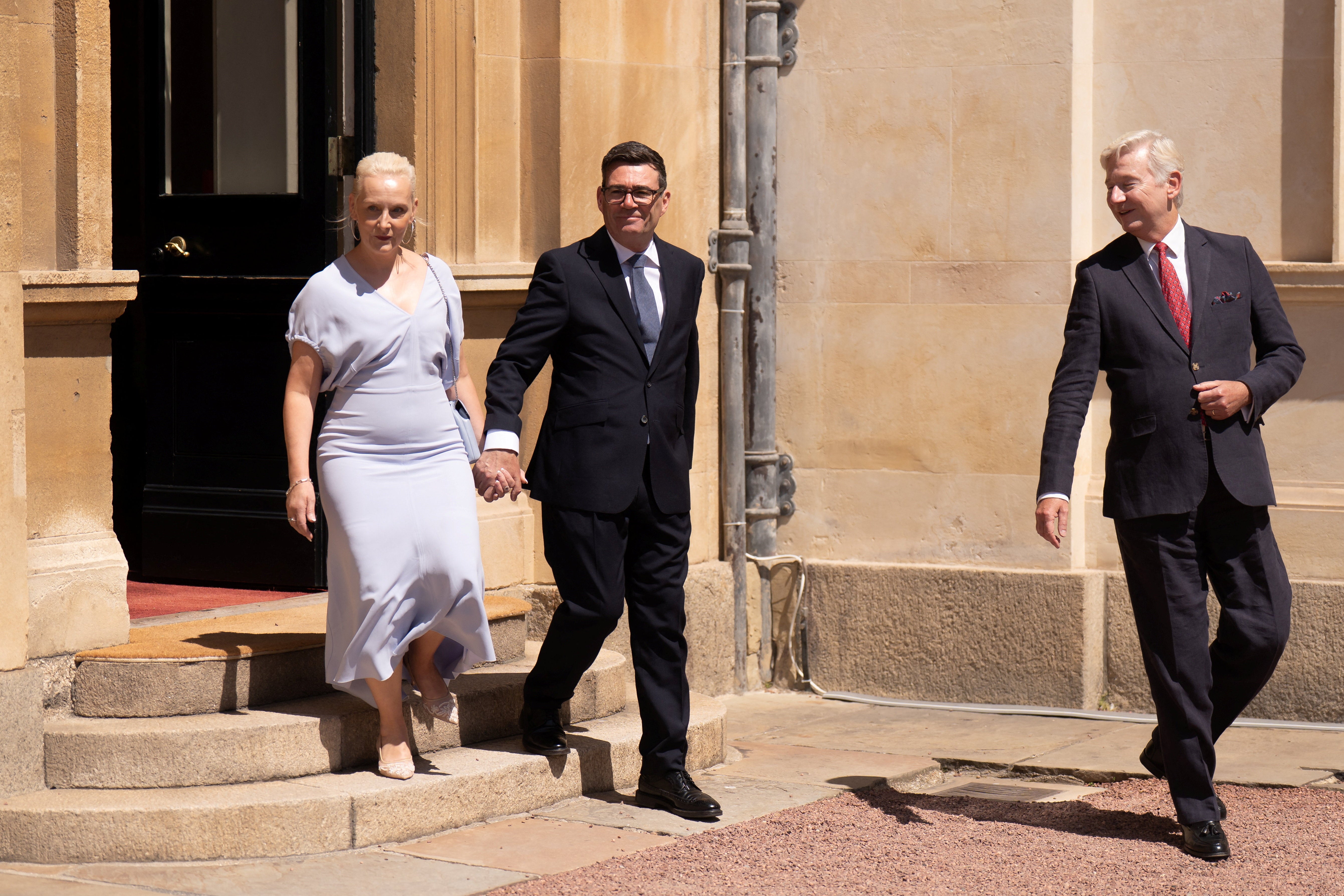 Britain's newly appointed Prime Minister, Andy Burnham, and his wife, Marie-France van Heel, leave Buckingham Palace in London after an audience with King Charles