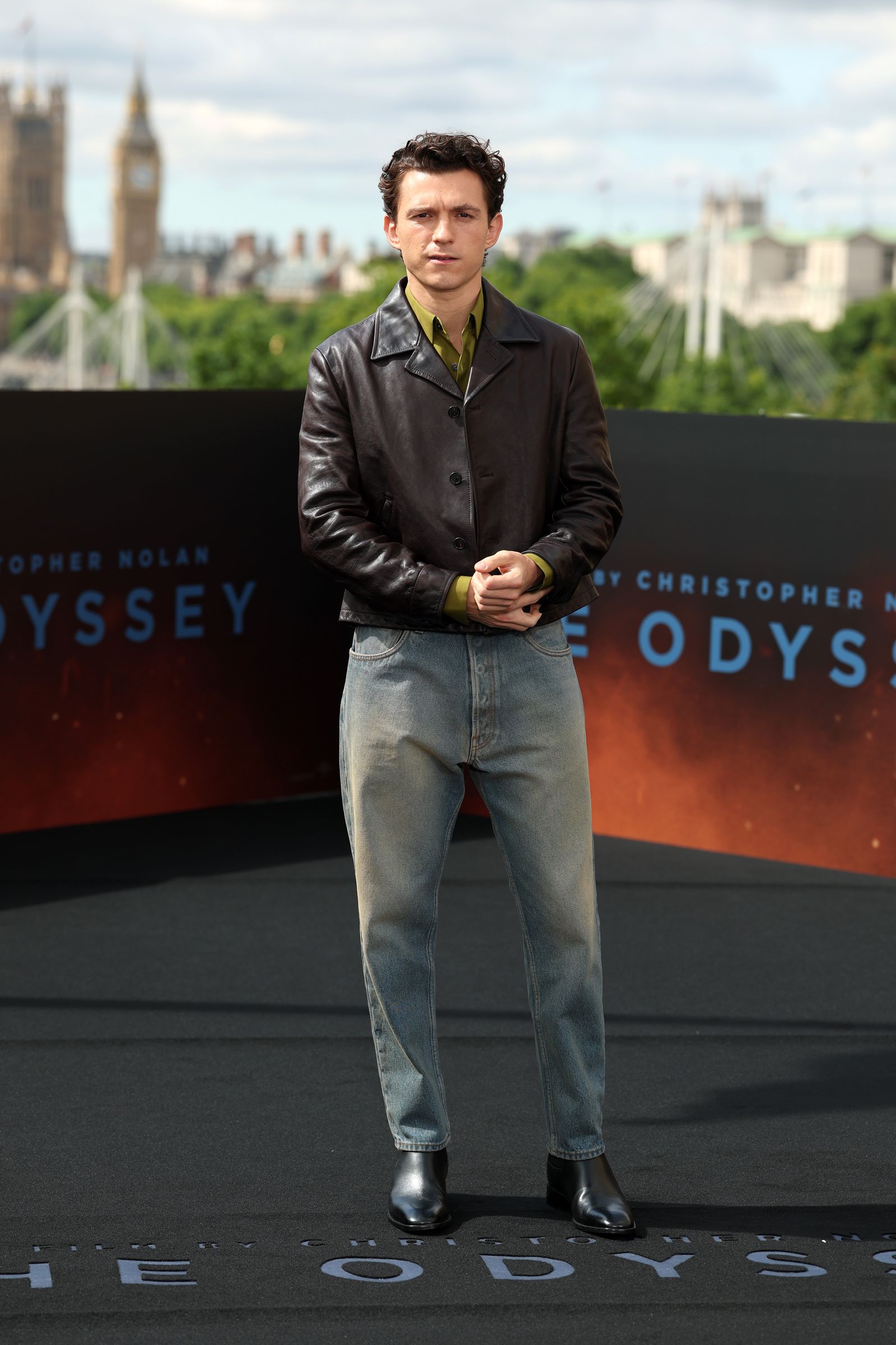 Image may contain Tom Holland Clothing Pants Coat Jacket Person Standing Blazer Adult and Jeans