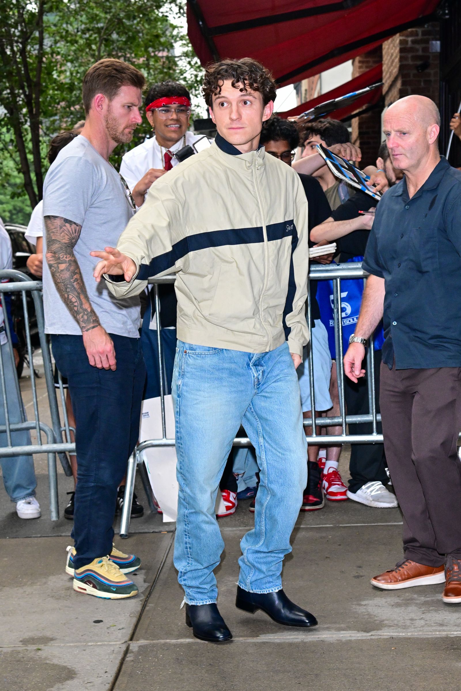 Image may contain Tom Holland Elías Jaua Clothing Pants Jeans Adult Person Footwear Shoe Face and Head