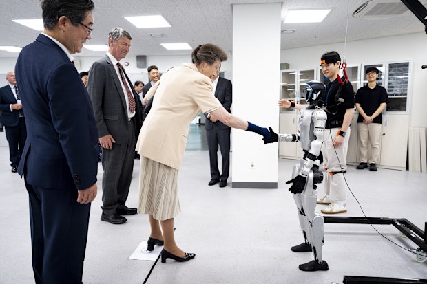 Princess Anne shakes hands with a robot in South Korea companied by her husband Vice Admiral Sir Tim Laurence shakes the hand of a robot during a visit to the Jung Woonoh IT & General Education Center on the on the Seoul campus of Korea University, during her visit to the Republic of Korea, also known as South Korea, on July 15, 2026.