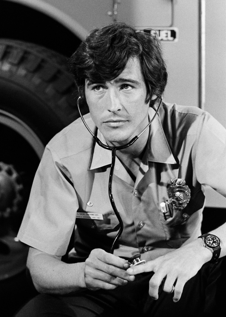 A black and white photo of actor Randolph Mantooth in character as a paramedic.