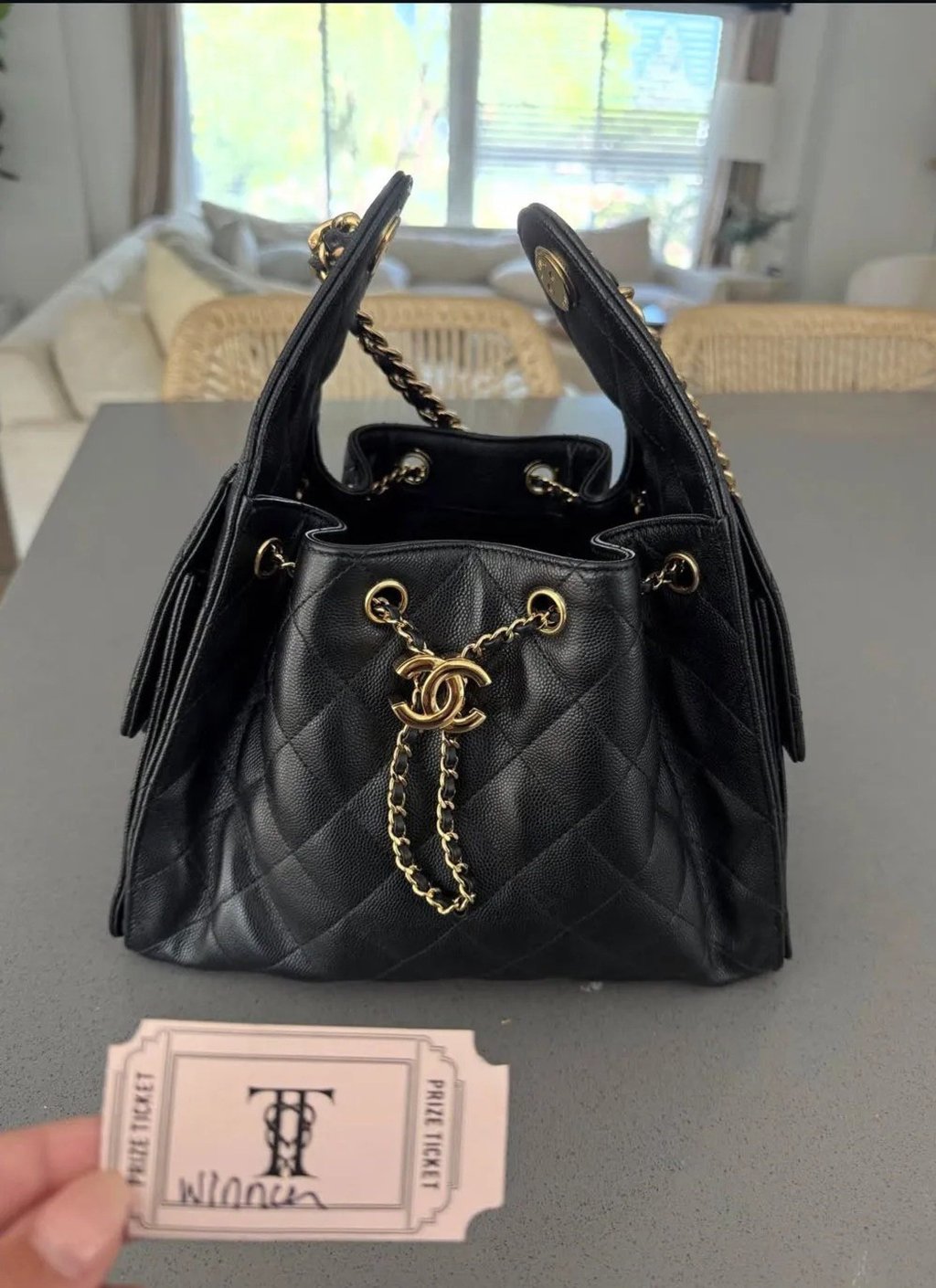 Jackie Tranquill posted a photo of a Chanel handbag and a prize ticket marked with Taylor Swift and Travis Kelce’s wedding logo. Photo: @jackietranquill/Instagram