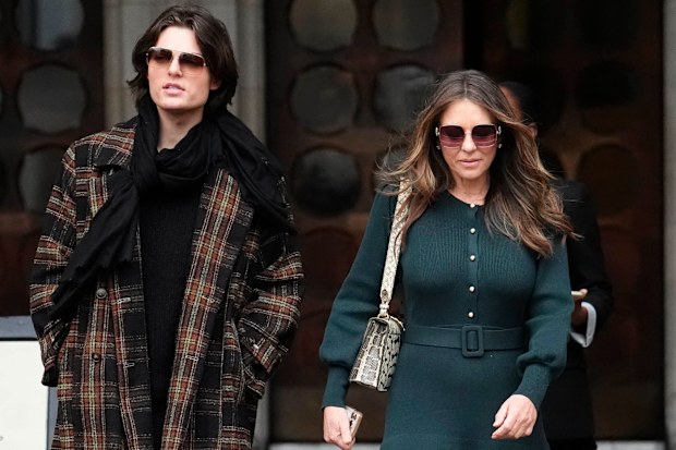 Elizabeth Hurley, right, leaves the Royal Courts of Justice on day four of the trial over allegations of unlawful information gathering brought against Associated Newspapers Limited, Thursday, Jan. 22, 2026