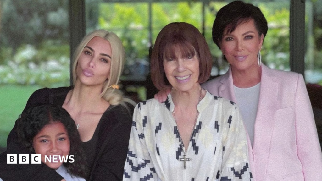 Mother of Kardashian matriarch Kris Jenner, Mary Jo, dies at 91 This photo shows Kim, her daughter, Mary Jo and Kris posing together smiling. They are standing by some bright pink flowers.