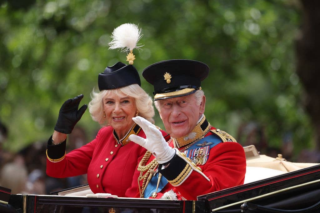 Enjoying the sunshine, the King and Queen wave to the crowds from their Ascot Landau