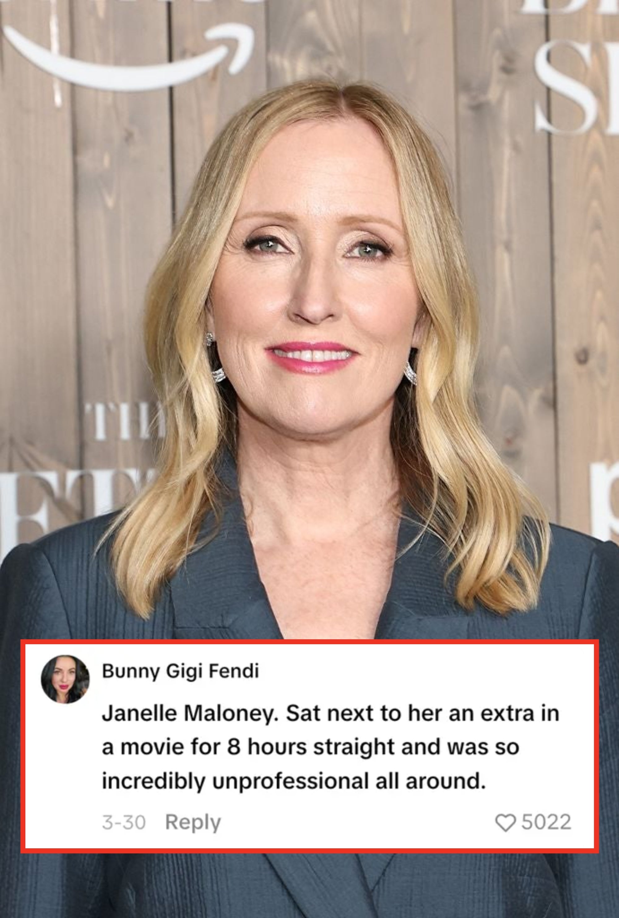 Person in a tailored suit with a wood-textured background at a celebrity event