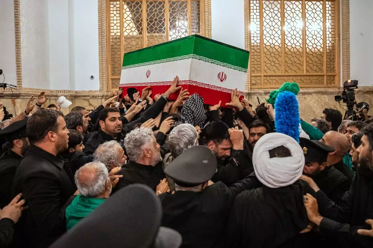 In this photo released by Iran's Supreme Leader's office, mourners carry the coffin of the late Iranian Supreme Leader Ayatollah Ali Khamenei above the crowd for the final prayer before his burial at the Imam Reza Shrine in Mashhad, northeastern Iran, Thursday, July 9, 2026. (Office of the Iranian Supreme Leader via AP)