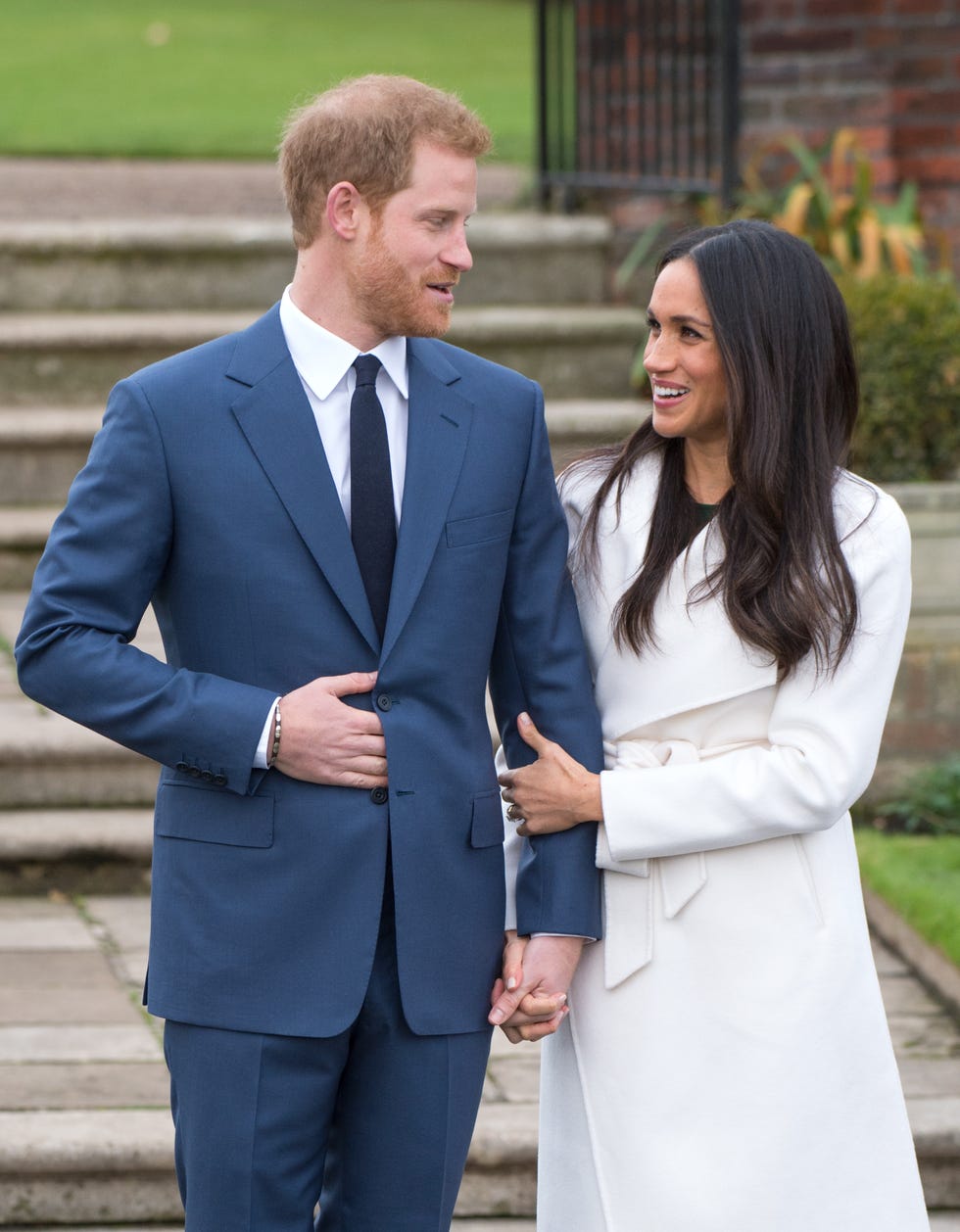 london, england november 27: prince harry and meghan markle, wearing a white belted coat by canadian brand line the label, attend a photocall in the sunken gardens at kensington palace following the announcement of their engagement on november 27, 2017 in london, england. (photo by anwar hussein/getty images)