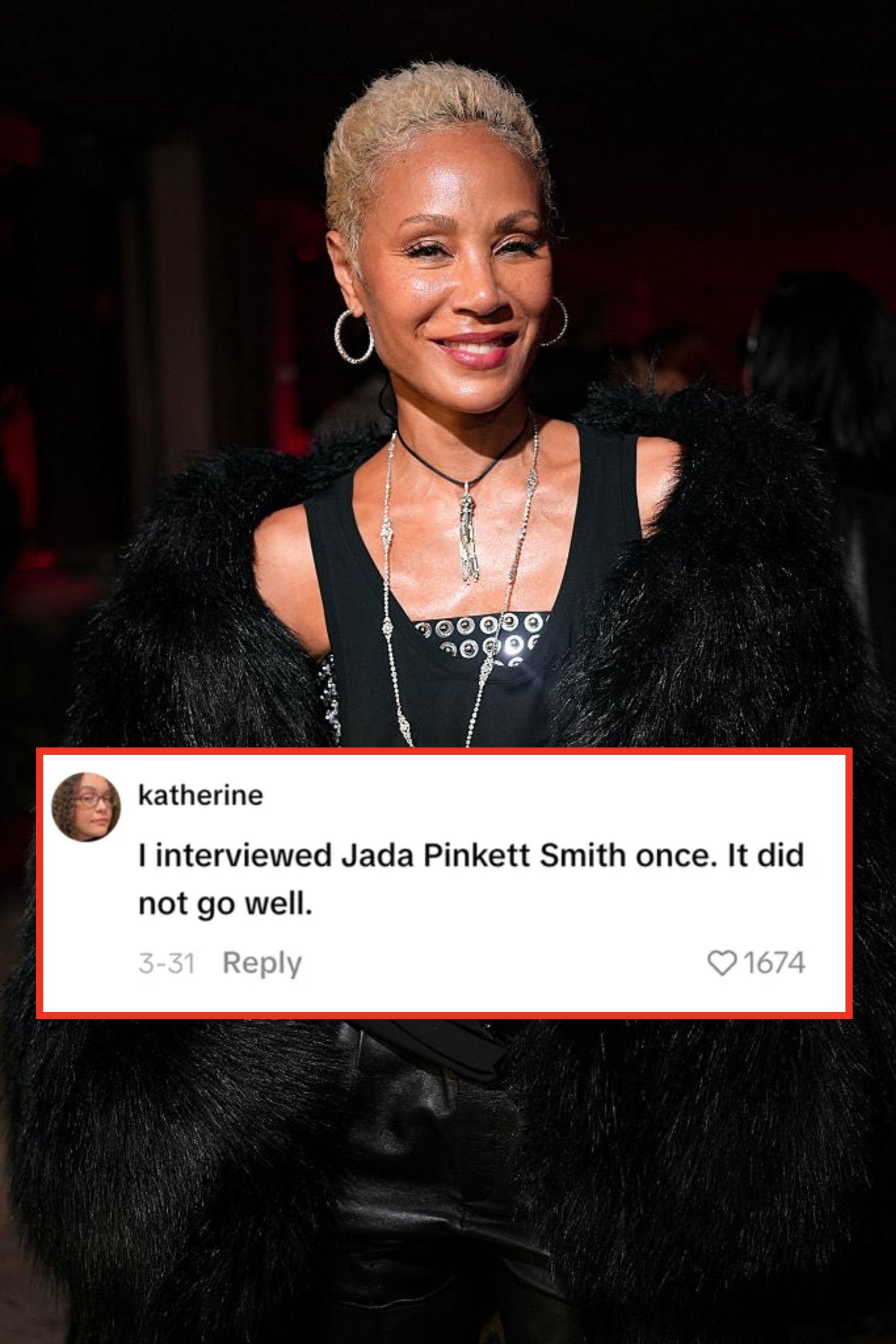 Person in a stylish black outfit with faux fur coat and layered necklaces attends a celebrity event