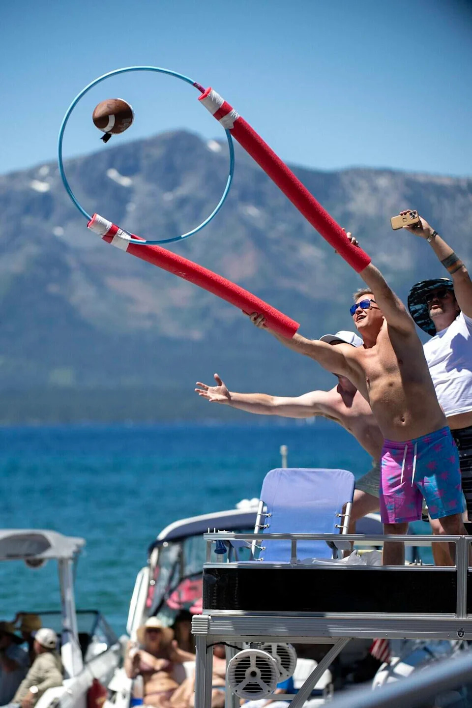 Fans engage with celebrity golfers as they get their football autographed and returned on the 17 tee during the American Century Championship at Edgewood Tahoe Golf Course in Stateline, Nev., on Friday, July 10, 2026.