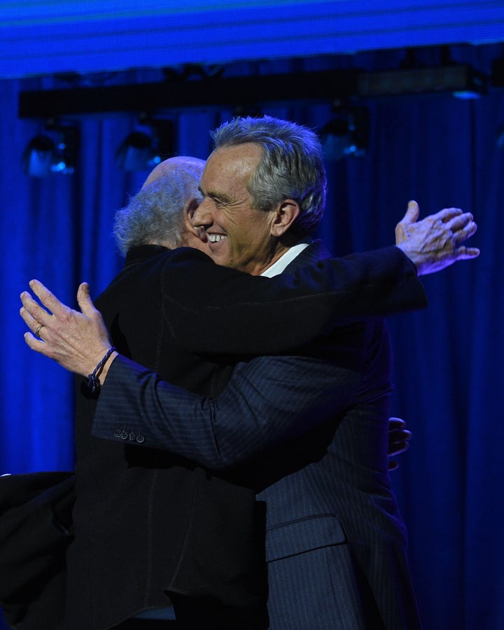 Larry David (left) hugs Robert Kennedy Jr. onstage at the Keep It Clean To Benefit Waterkeeper Alliance on March 1, 2018, in Los Angeles, California.