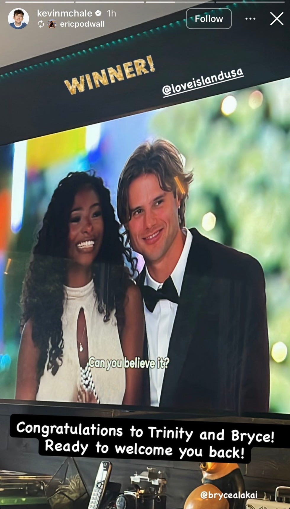 Couple celebrating their win on a television screen with the text "Congratulations to Trinity and Bryce! Ready to welcome you back! Couple celebrating their win on a television screen with the text "Congratulations to Trinity and Bryce! Ready to welcome you back!