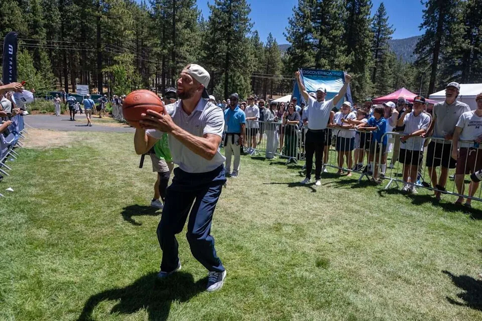 The Sacramento Kings Zach LaVine shoots a basketball before getting to the 18th tee as former NFL quarterback Derek Carr reacts during the American Century Championship at Edgewood Tahoe Golf Course in Stateline, Nev., on Friday, July 10, 2026.