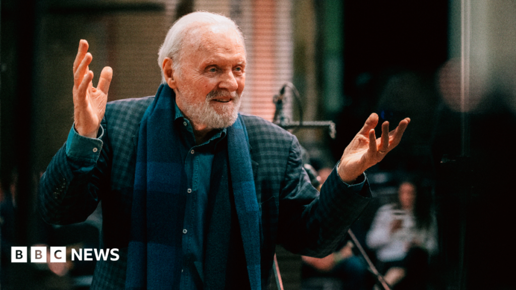 Sir Anthony Hopkins to release debut album Life is a Dream Sir Anthony Hopkins in a music studio. He wears a green and dark blue checked blazer and a blue plaid scarf, with a denim shirt underneath. He has both hands in the air and smiles.