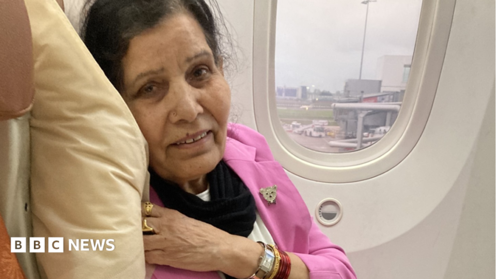 Wolverhampton woman’s leg-removal forces by delay over blood clot – lawyers A woman with dark hair and a pink jacket in a white aeroplane seat with a window behind her