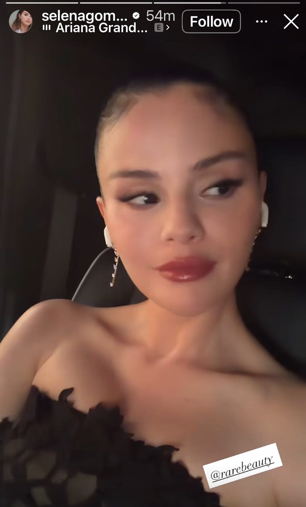 A close-up of a woman with long dark hair, elegant makeup, and stylish ear accessories, sitting in a car. A close-up of a woman with long dark hair, elegant makeup, and stylish ear accessories, sitting in a car.
