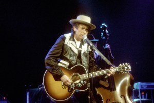1992: Bob Dylan plays a Gibson J200 acoustic guitar as he performs on stage in 1992. (Photo by Larry Hulst/Michael Ochs Archives/Getty Images)