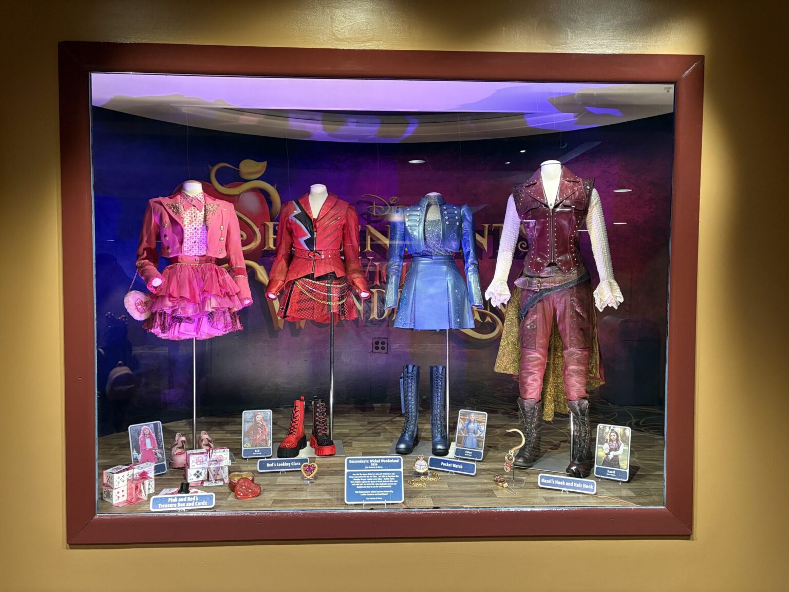 ‘Descendants: Wicked Wonderland’ Costumes and Props Arrive at Disney’s Hollywood Studios One of the costumes on display is that of Queen of Hearts, played by Rita Ora. It includes her dress, boots, and crown.