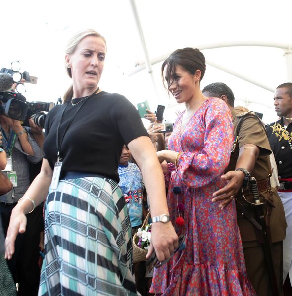Meghan and a flustered looking aide.