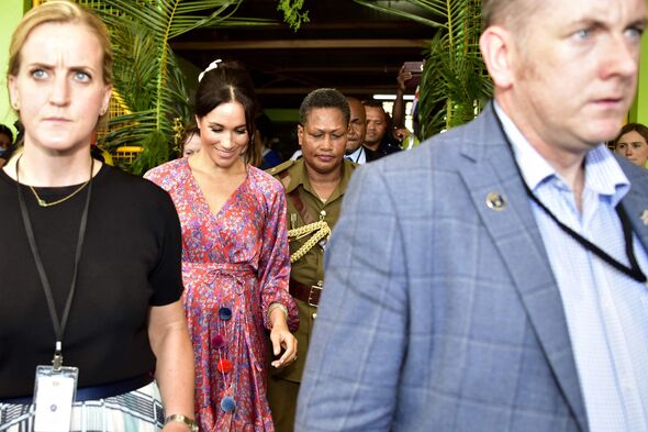 Meghan leaving with aides.