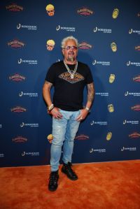 LAS VEGAS, NEVADA - JULY 07: Guy Fieri poses on the orange carpet at the grand opening of Guy Fieri's Flavortown Sports Kitchen at Horseshoe Las Vegas on July 07, 2023 in Las Vegas, Nevada. (Photo by Denise Truscello/Getty Images for Caesars Entertainment)