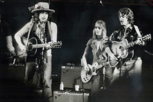 TORONTO, ON - DECEMBER 2, 1975: His rolling thunder revue making its way toward New York, Bob Dylan (left) last night took centre stage before 16,000 people at Gardens, accompanied by a host of other folk music personalities including Mick Ronson (centre) and Bobby Neuwirth. Joni Mitchell was there, and Ramblin' Jack Elliott and Ronee Blakley and Roger McQuinn and Gordon Lightfoot. Joan Baez joined in duet with Dylan, her dignity filling hall, according to Star writer Peter Goddard. (Frank Lennon/Toronto Star via Getty Images)