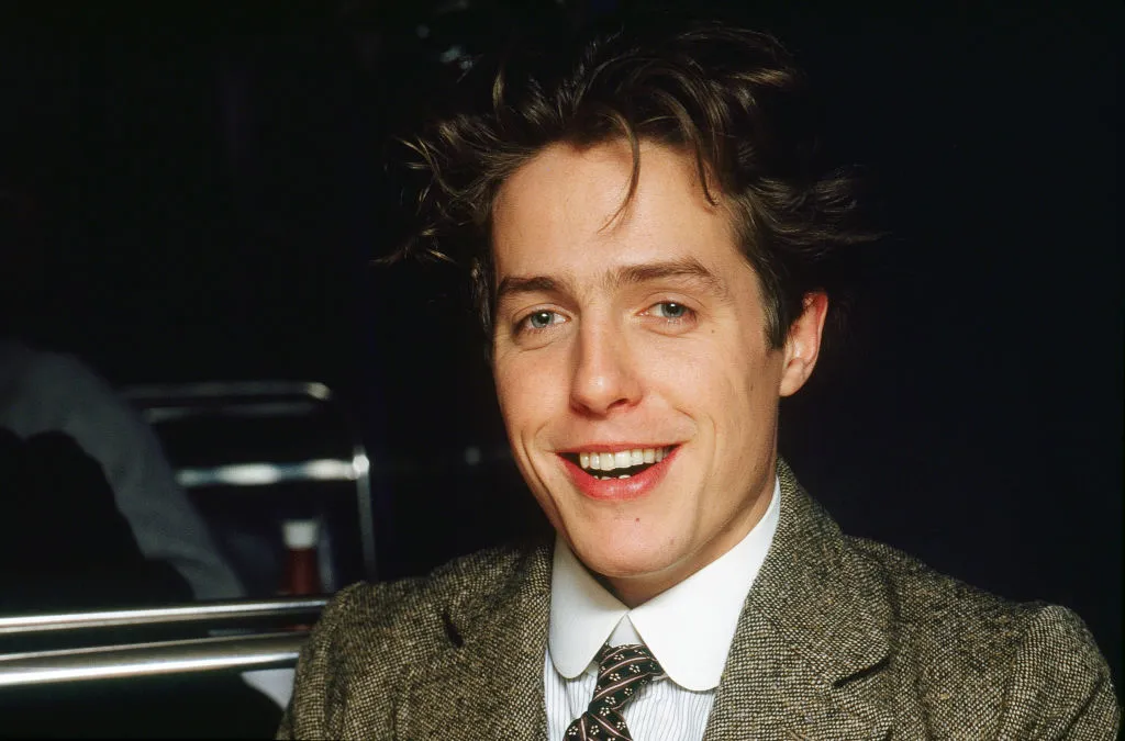 Close-up of British actor Hugh Grant (in costume as Clive Durham) during the filming of 'Maurice' (directed by James Ivory), London, England, December 1986.