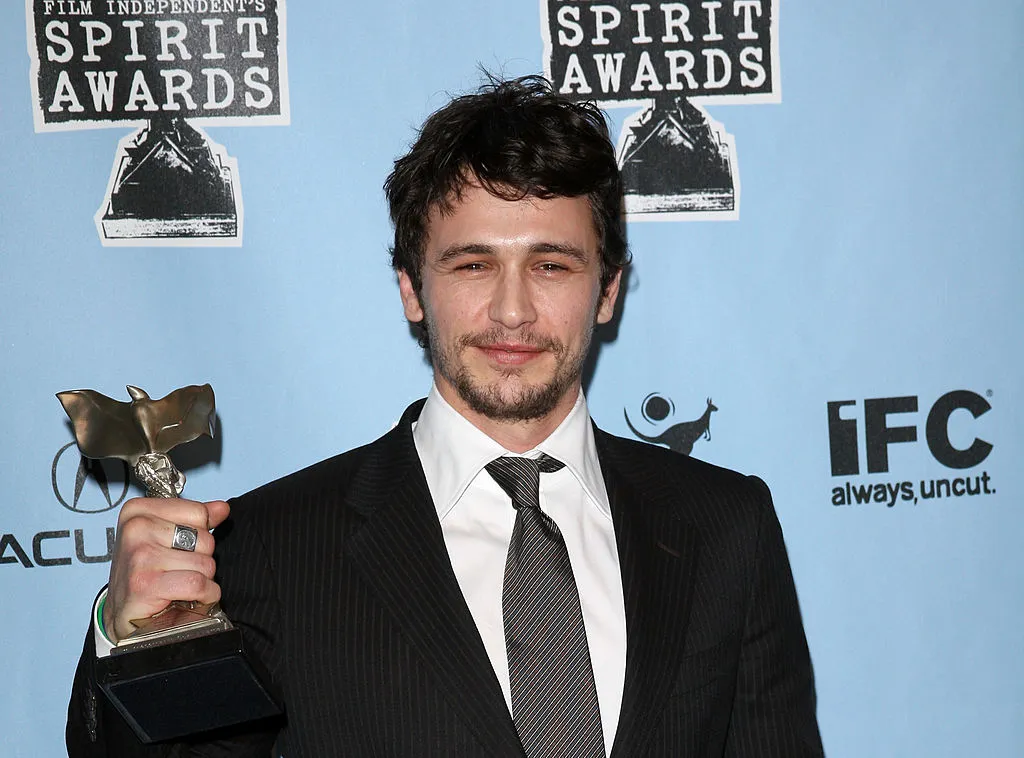 Actor James Franco poses with the Best Supporting Male award for 