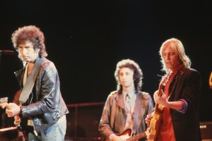 Music Legend Bob Dylan on stage with Tom Petty and the Heartbreakers. Mike Campbell, Heartbreakers' guitarist, is in the background. (Photo by LGI Stock/Corbis/VCG via Getty Images)