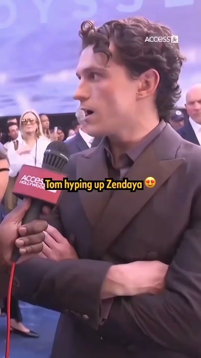 Zendaya blushing as Tom Holland hypes her at the premiere of "The Odyssey" in London (July 6, 2026)