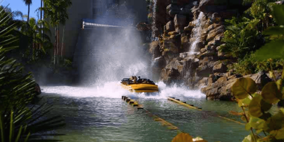 guests splash down Universal Orlando's Jurassic Park River Adventure boat ride
