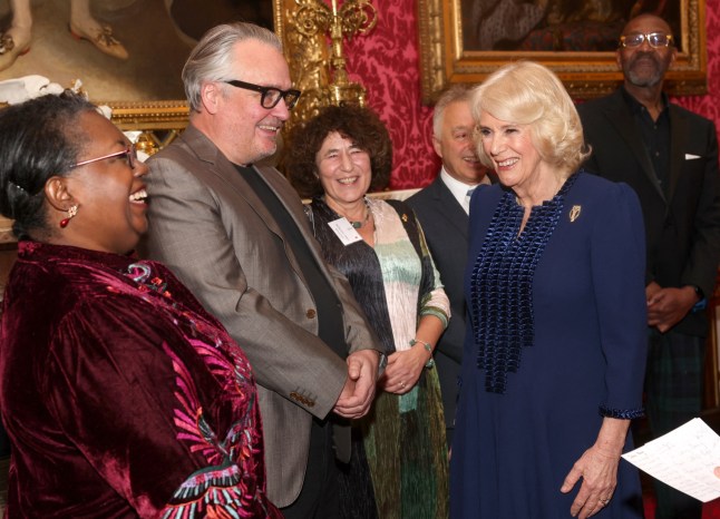 Britain's Queen Camilla (R) shares a joke with British writers Malorie Blackman (L), Charlie Higson (2L) and US-British writer Francesca Simon (3L) during a reception for the BBC's 500 Words Finalists at Buckingham Palace on February 28, 2024 in London. (Photo by Chris Jackson / POOL / AFP) (Photo by CHRIS JACKSON/POOL/AFP via Getty Images)