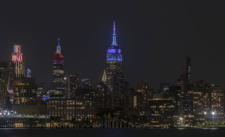 HOBOKEN, NJ - JULY 3: The Empire State Building illuminates in blue to mark the wedding of Taylor Swift in New York City on July 03, 2026, as seen from Hoboken, New Jersey. (Photo by Gary Hershorn/Getty Images)