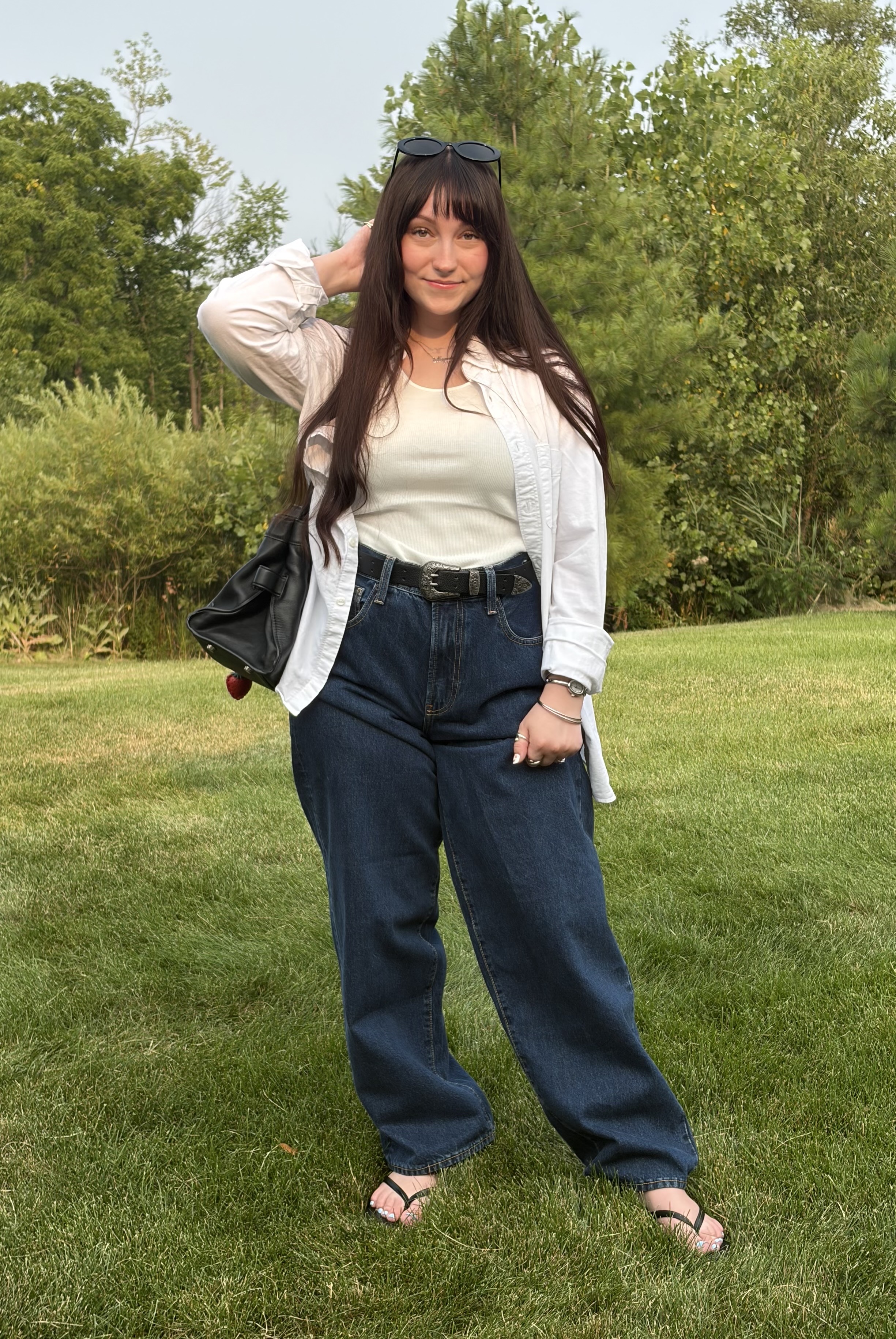 Meguire Hennes poses in dark-wash jeans from Hailey Bieber's denim Gap collection