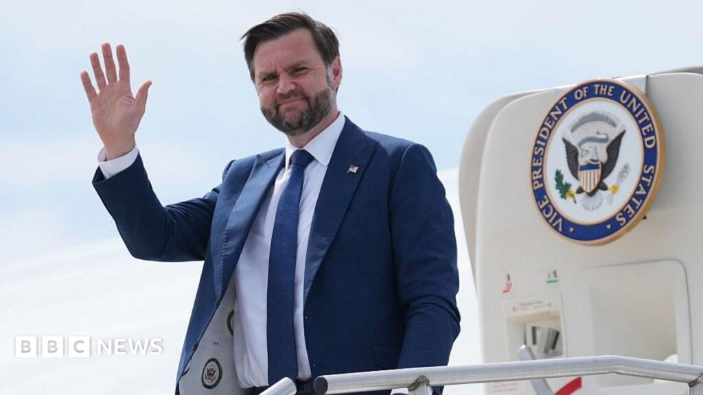 JD Vance says Caernarfon castle was ‘coolest thing I’ve ever seen’ JD Vance waving as he steps out of a jet with the presidential seal on the door. He wears a blue suit with a white shirt and blue tie, and has a pin on his lapel with the US flag on it.