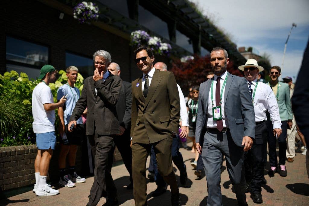 Former tennis player Roger Federer walks around the premises on day eight of The Championships
