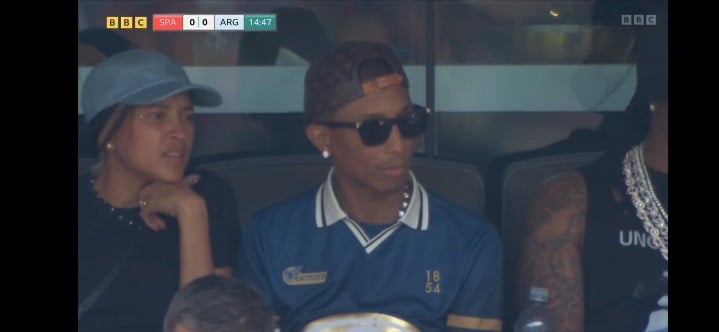 Pharrell Williams appears on screen at the FIFA World Cup final between Spain and Argentina. Commentator Guy Mowbray says, "I think that's AKA Rocky"