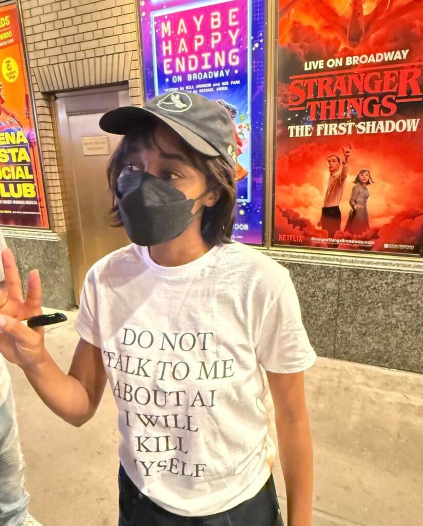 Ayo Edebiri wearing a "Do not talk to me about AI. I will kill myself." shirt
