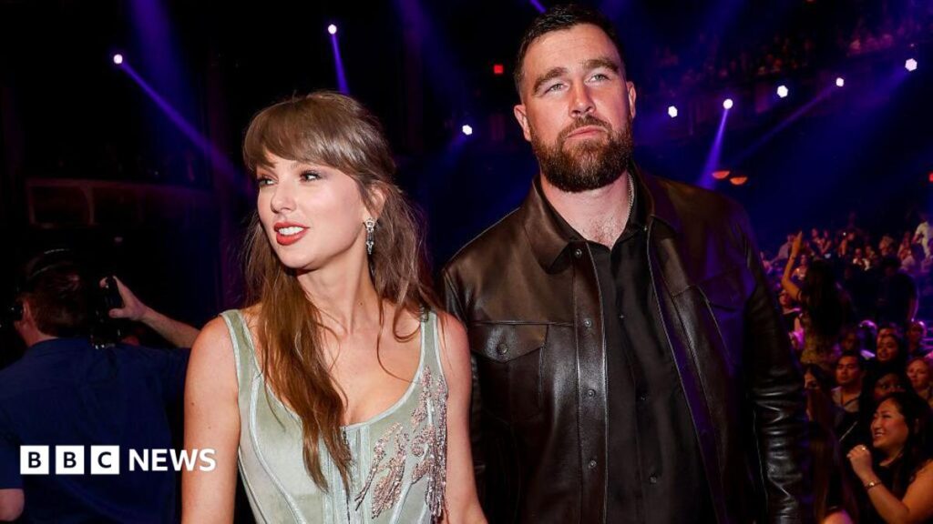 What we know about Taylor Swift’s rumoured NYC wedding celebrations A woman stands silhouetted on the banks of the River Thames, holding a purple umbrella for shade.