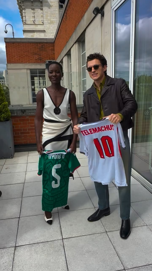 Lupita Nyong’o and Tom Holland with their respective countries (Mexico and England) national football shirts as they face off in the Round of 16
