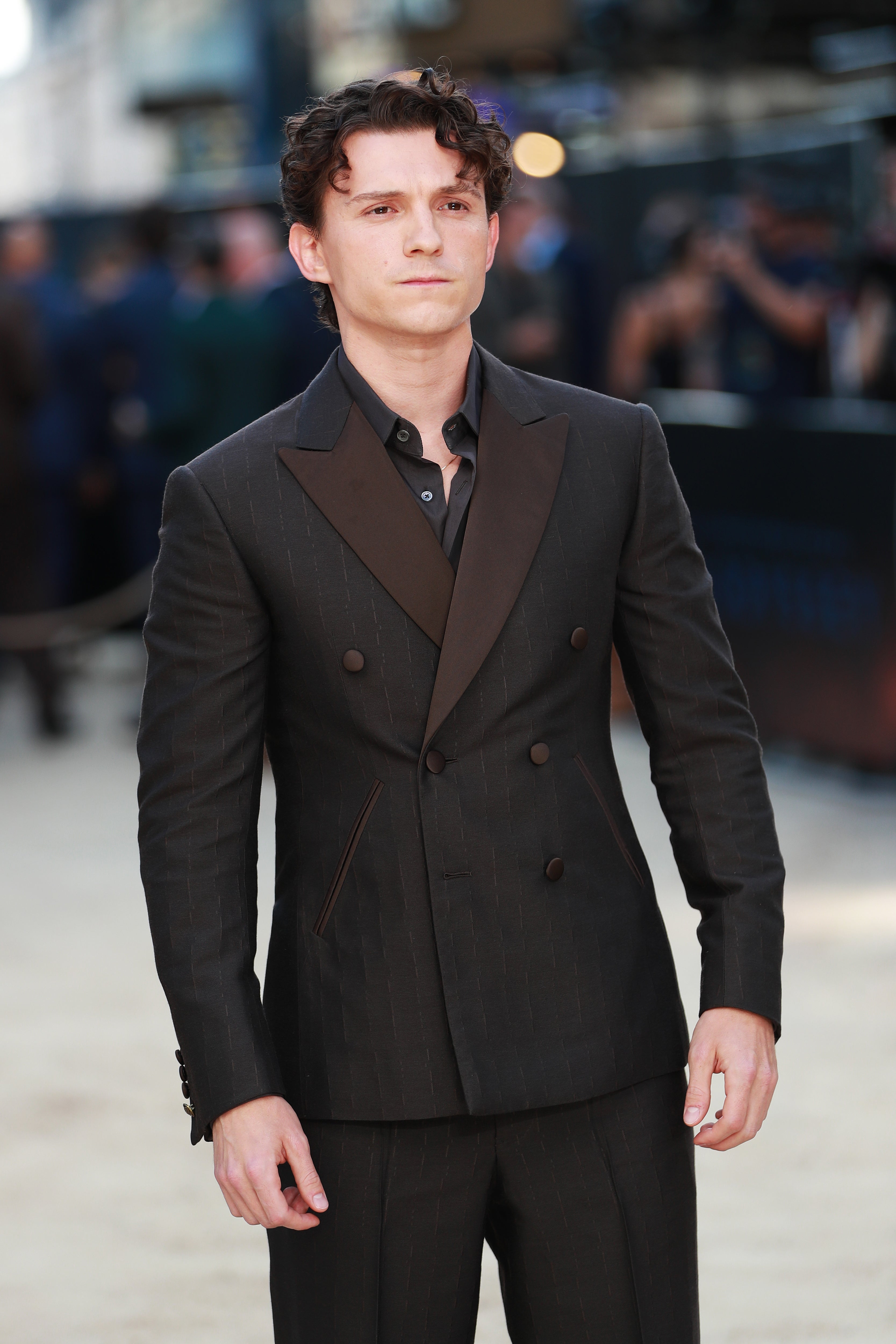 Person in a double-breasted suit with wide lapels on a red carpet