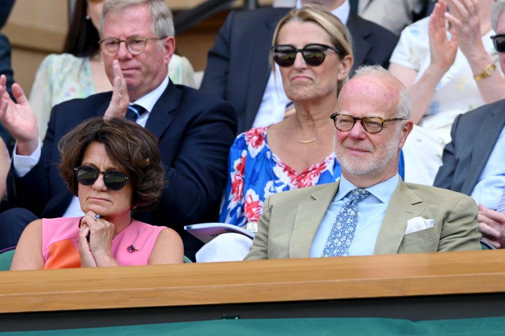 Sylvana Tomaselli and George Windsor in formal attire at an event, clapping and watching attentively.