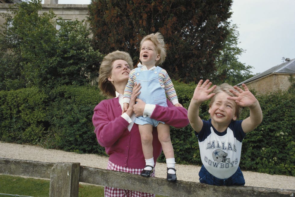 princes william and harry with their mother, diana, princess of wales (1961 1997) in the garden of highgrove house in gloucestershire, 18th july 1986. william is wearing a dallas cowboys t shirt.(photo by tim graham photo library via getty images)
