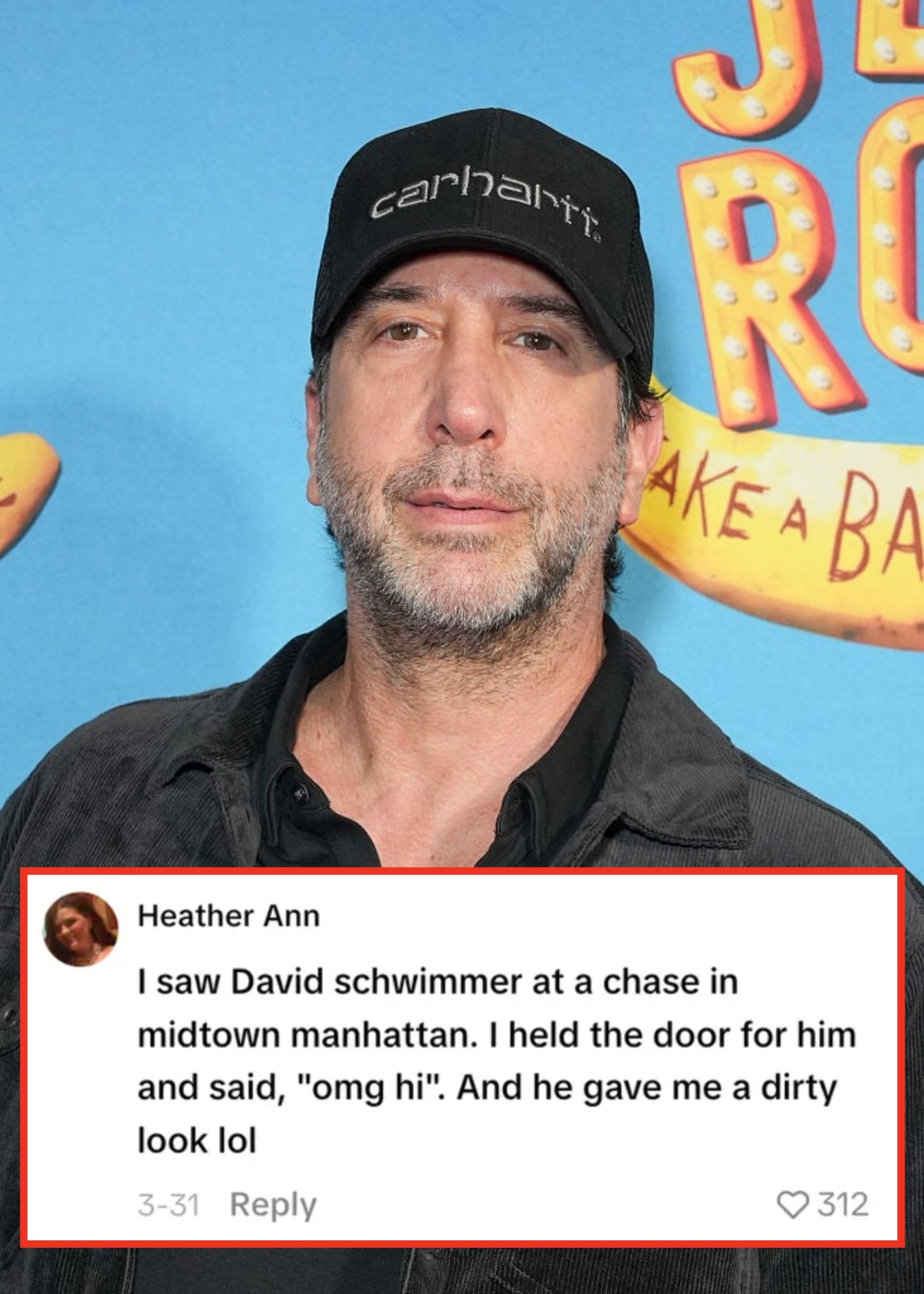 Person wearing a black Carhartt cap and casual jacket at a celebrity event. Bright, playful signage in the background