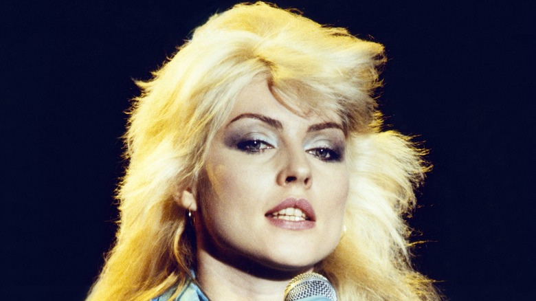 Debbie Harry during a performance with bright blond hair and silver smoky eyeshadow