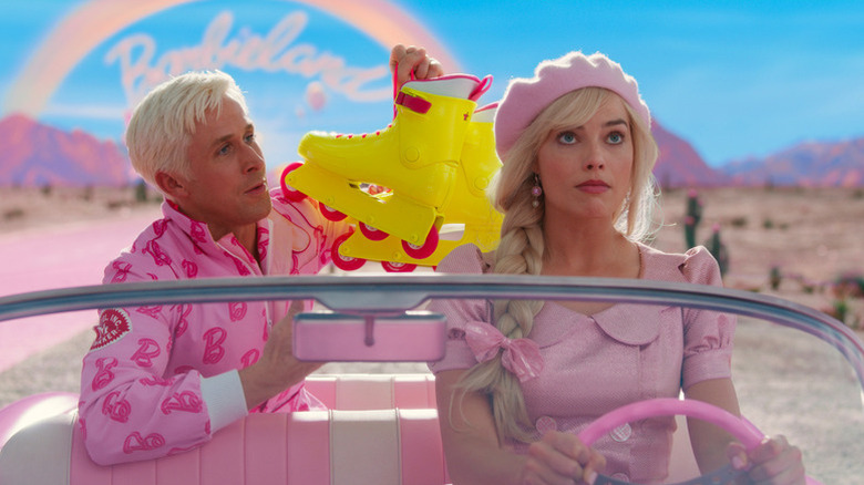 Ken holding his rollerblades behind Barbie in the car in Barbie