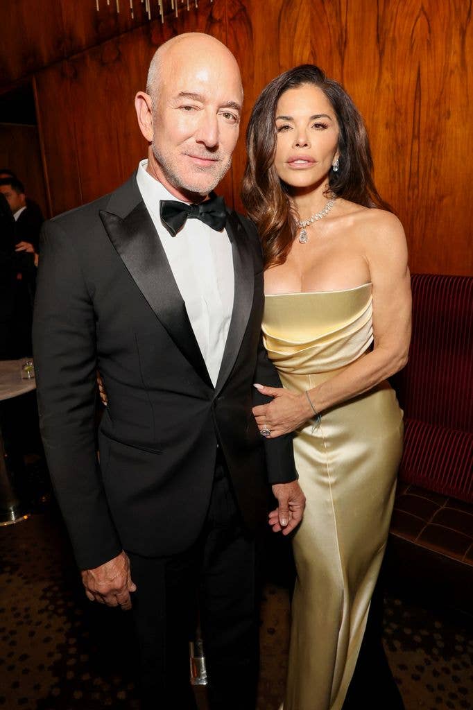 photo of lauren sanchez in gold dress with jeff bezos in tux