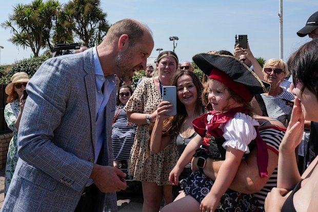 Prince William, Prince of Wales, chats with a young girl as he departs after playing a round of “crazy golf” during a visit to the Hastings Adventure Miniature Golf on July 09, 2026
